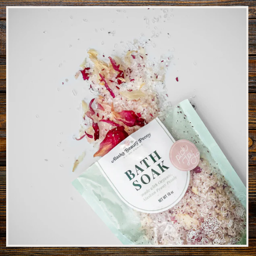 Bath soak with floral petals and packaging on a light background | Alaska Beauty Peony Cooperative | Homer, AK